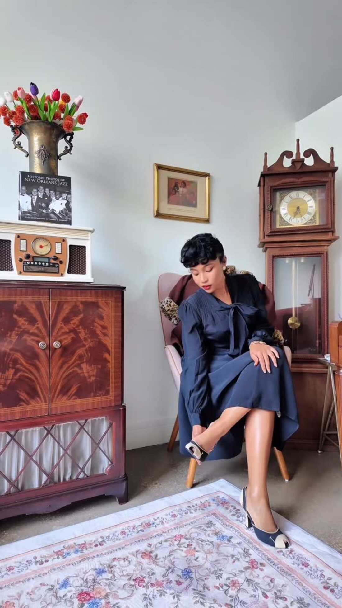 Cazlinn Carstens in a navy 1940s dress in her vintage-styled studio