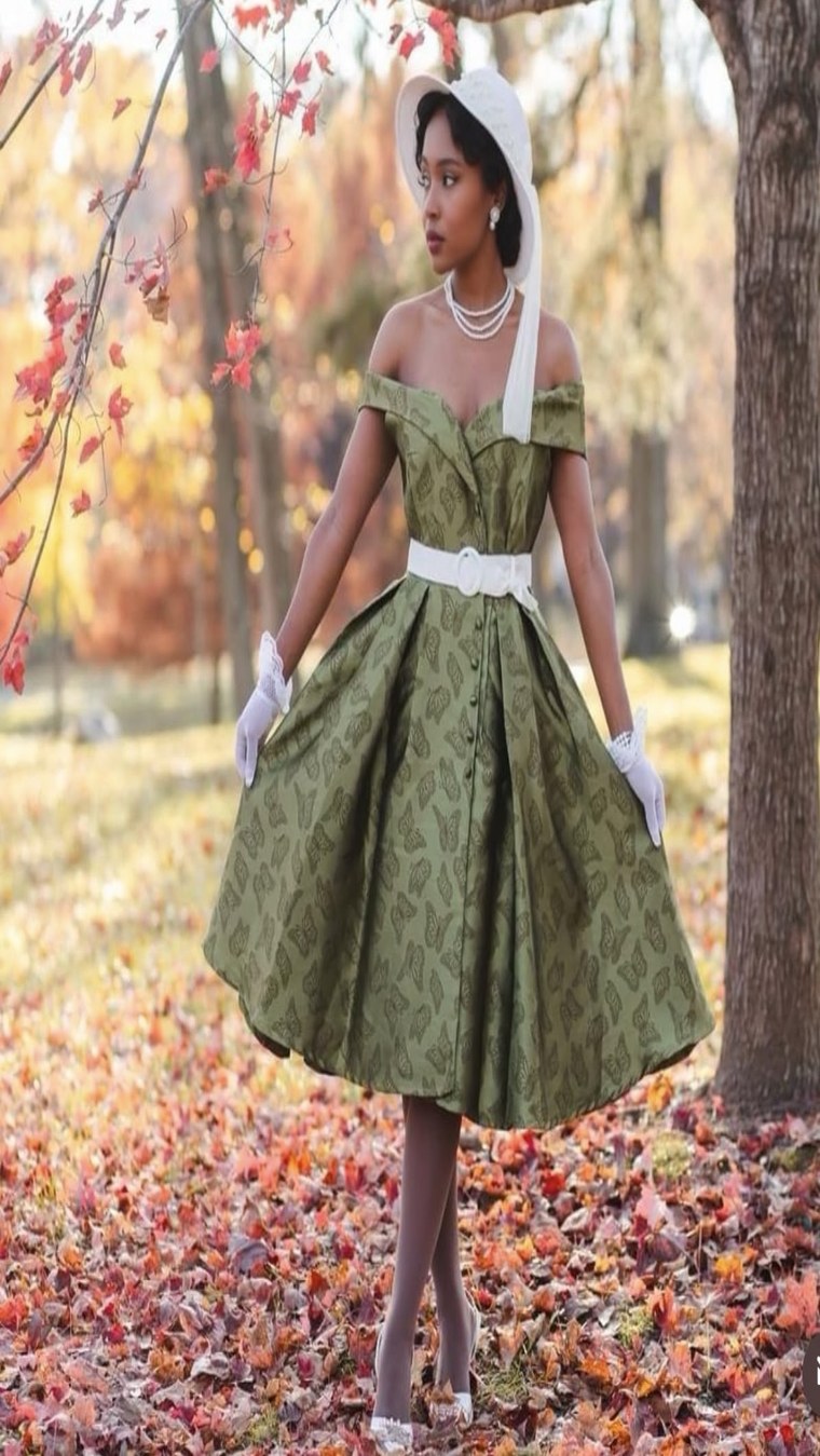 Green butterfly-print off-shoulder dress in a park