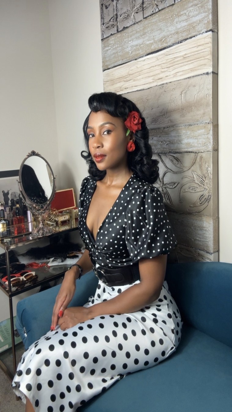 Polka-dot dress with a rose in her hair