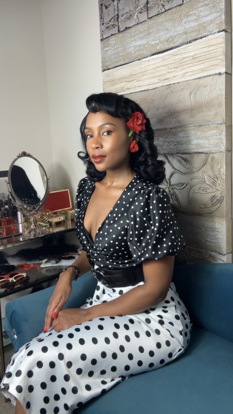 Polka-dot dress with a rose in her hair